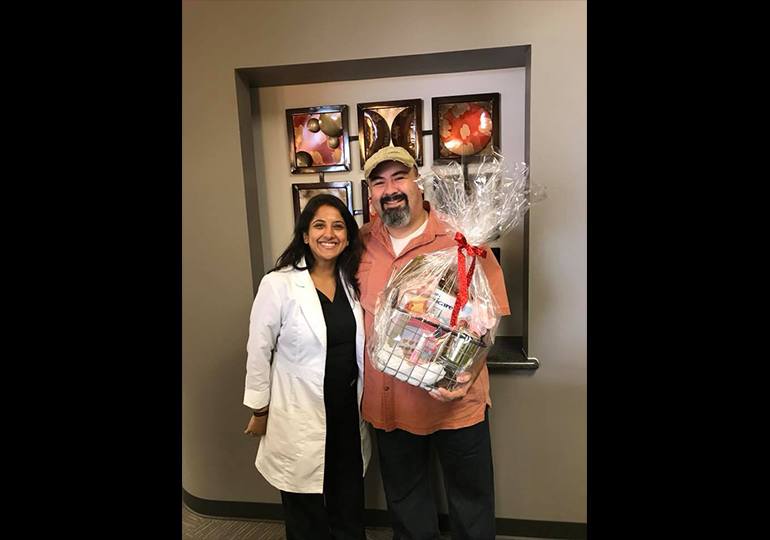 Dr. Fifadara and patient with a gift basket