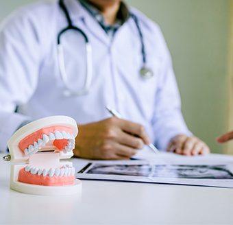 Dentist reviewing smile model and dental x-rays