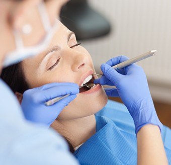 Relaxed woman receiving dental care