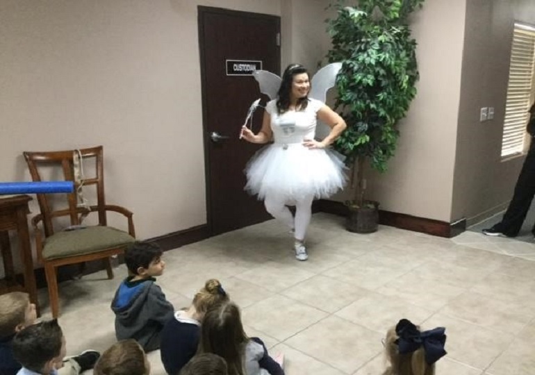 Team member dressed as tooth fairy for kid presentation