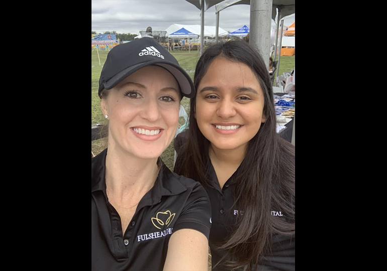 Outdoor event two team members smiling