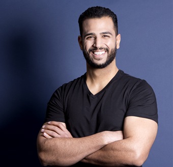 Smiling man in front of a blue background