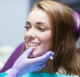 Woman having the shade of her tooth matched