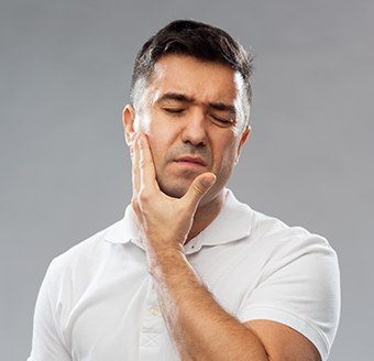 Man in pain holding jaw