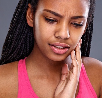 Woman in pain holding jaw