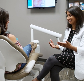 Dr. Fifadara talking to dental patient