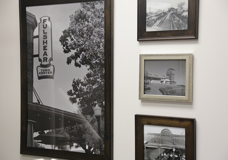 Photos of past dental offices on wall