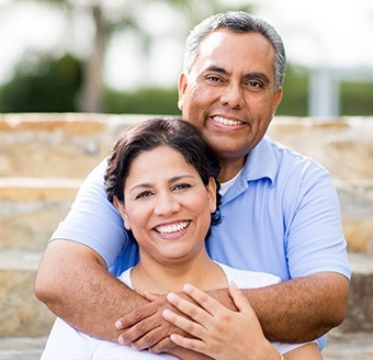 Older mand and woman smiling outdoors