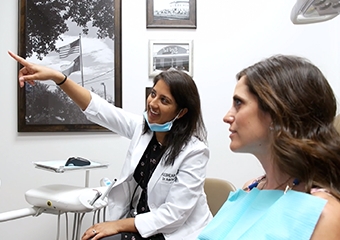 Dr. Fifadara showing patient dental x-rays